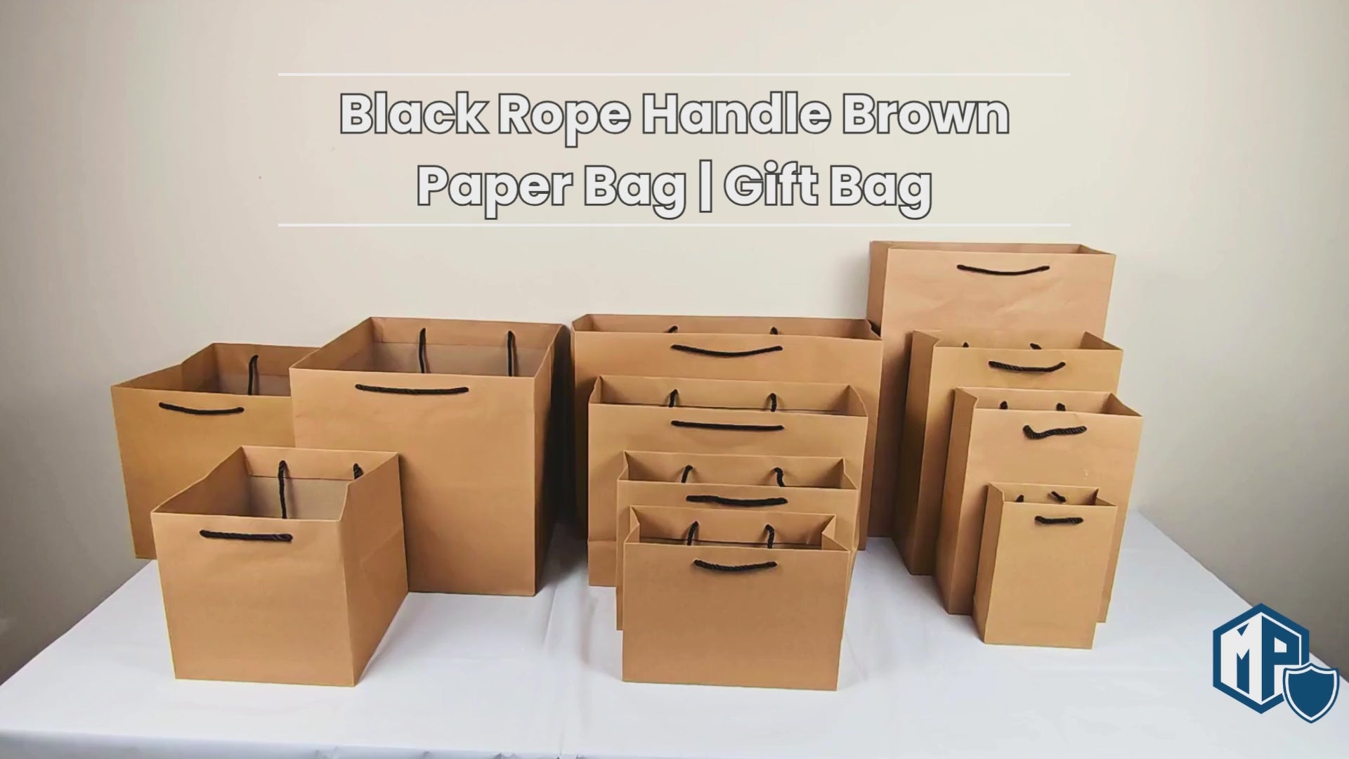 Brown paper bag with black rope handle, labeled as gift bag.