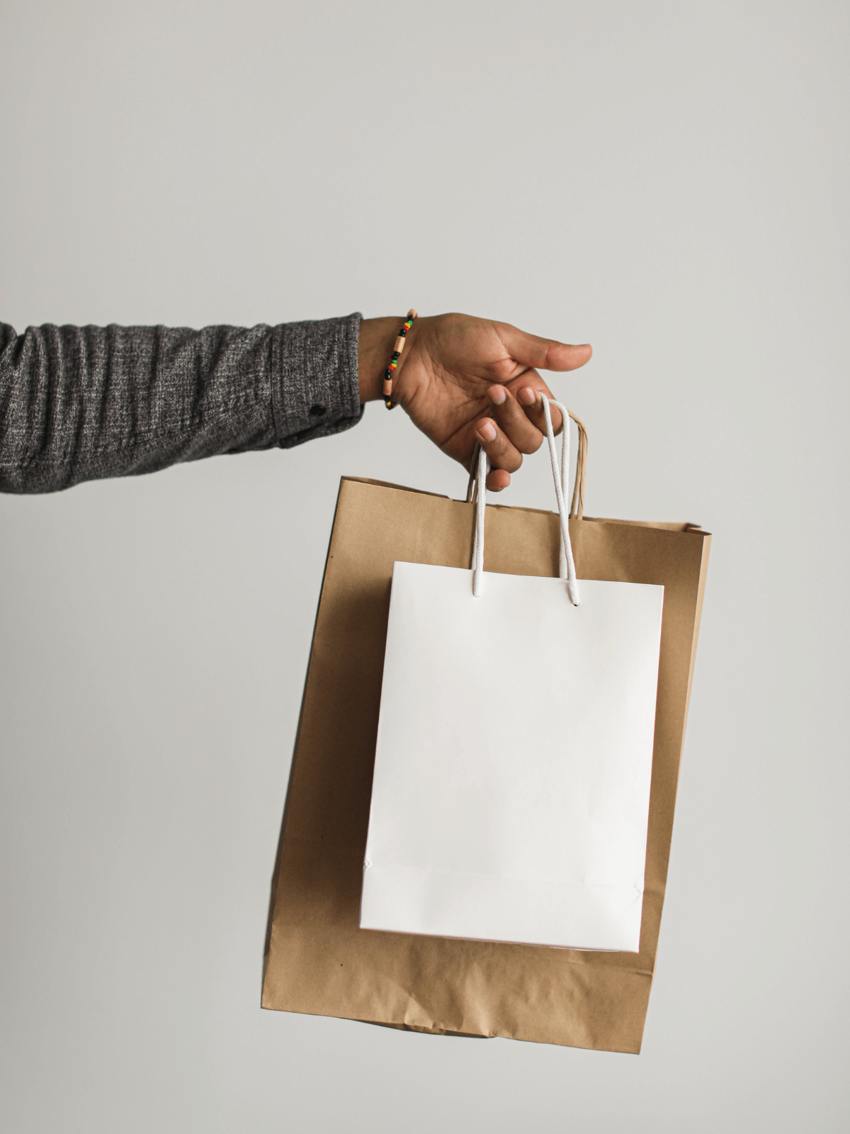 holding a paper bag in different size