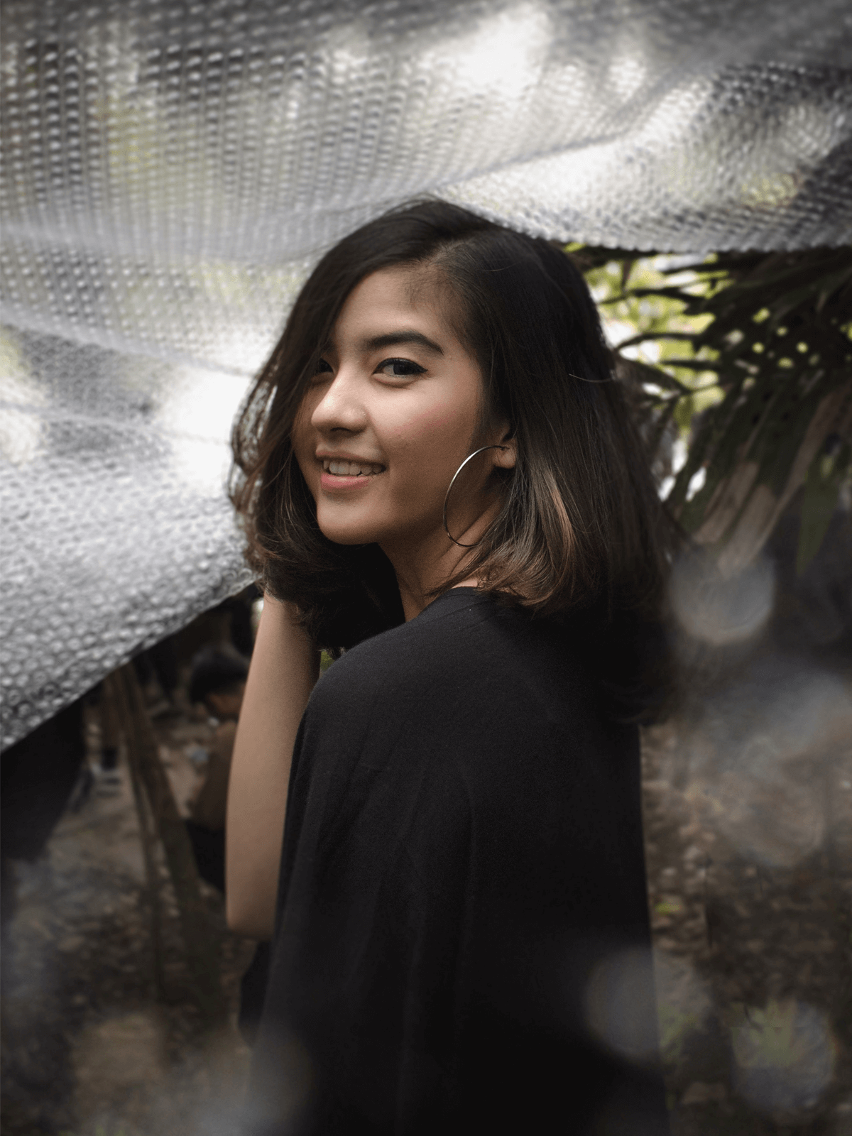 girl smiling with a plastic bubble wrap in her head